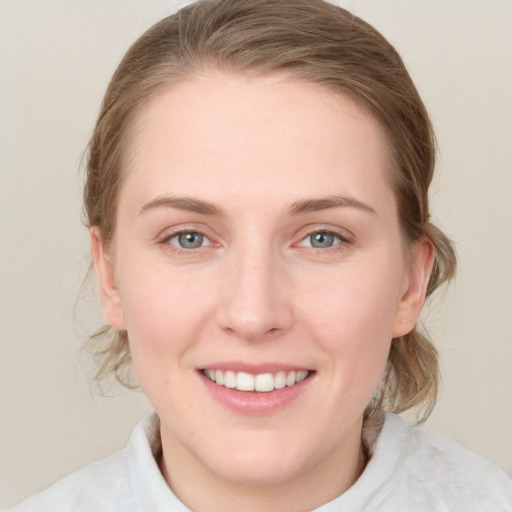 Joyful white young-adult female with medium  brown hair and blue eyes