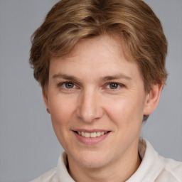 Joyful white adult male with short  brown hair and grey eyes