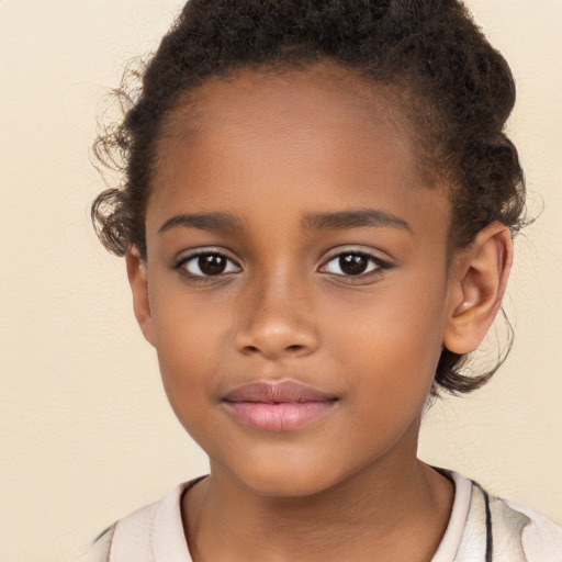 Joyful black child female with short  brown hair and brown eyes