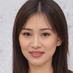 Joyful asian young-adult female with long  brown hair and brown eyes