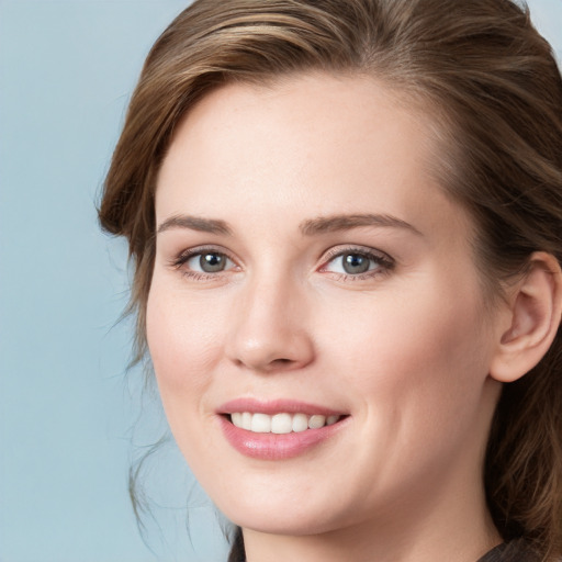 Joyful white young-adult female with medium  brown hair and blue eyes