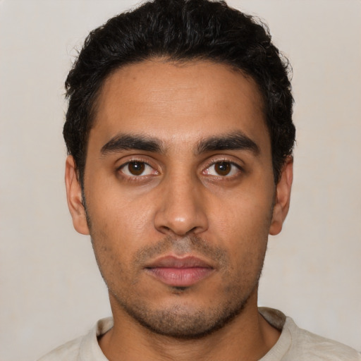 Neutral latino young-adult male with short  black hair and brown eyes