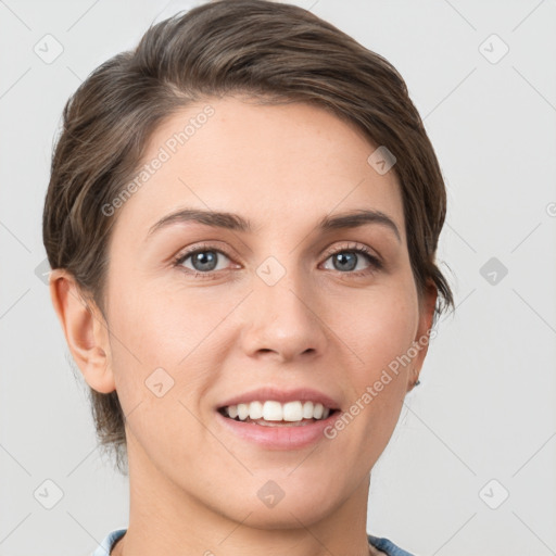 Joyful white young-adult female with short  brown hair and grey eyes