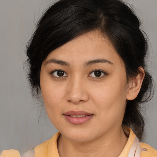 Joyful asian young-adult female with medium  brown hair and brown eyes