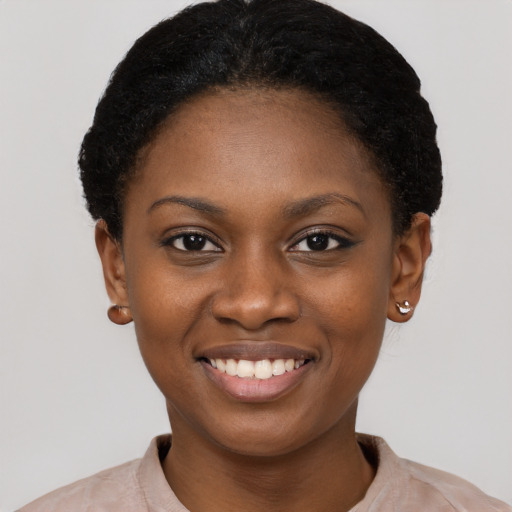Joyful black young-adult female with short  brown hair and brown eyes