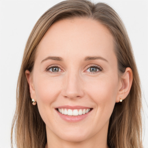 Joyful white young-adult female with long  brown hair and grey eyes