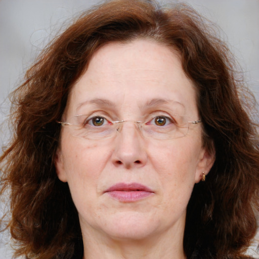 Joyful white adult female with medium  brown hair and blue eyes