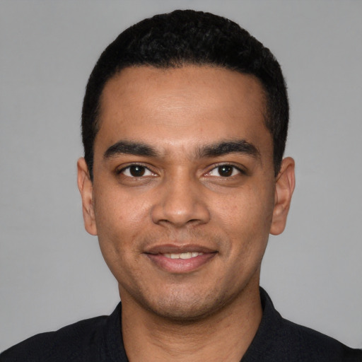 Joyful latino young-adult male with short  black hair and brown eyes