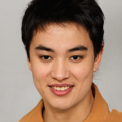 Joyful asian young-adult male with short  brown hair and brown eyes