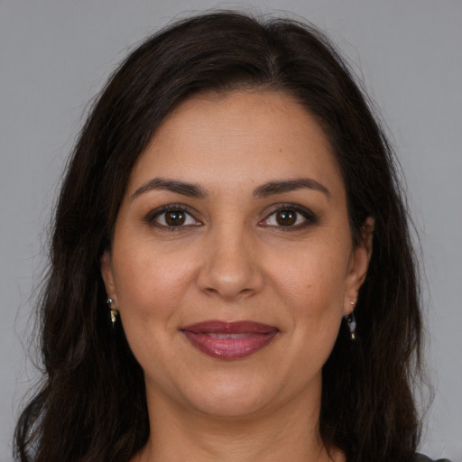 Joyful white adult female with long  brown hair and brown eyes