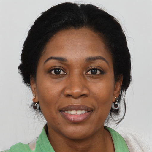 Joyful black adult female with medium  brown hair and brown eyes