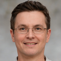 Joyful white adult male with short  brown hair and grey eyes