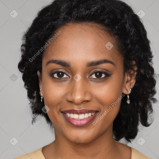 Joyful black young-adult female with long  black hair and brown eyes