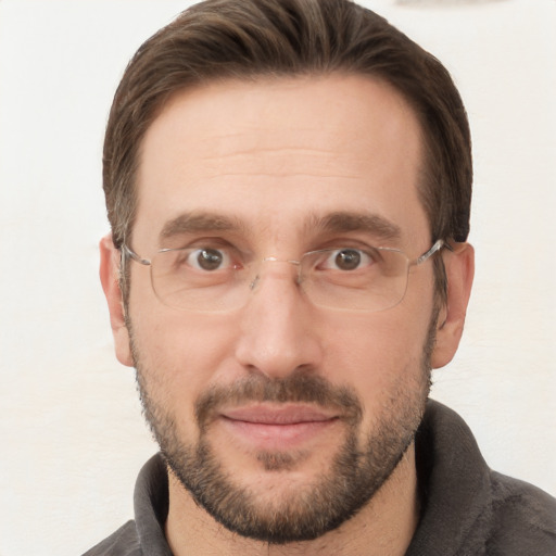 Joyful white adult male with short  brown hair and brown eyes