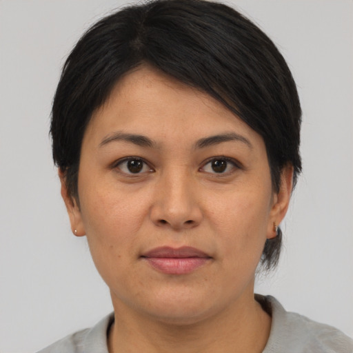 Joyful asian adult female with medium  black hair and brown eyes