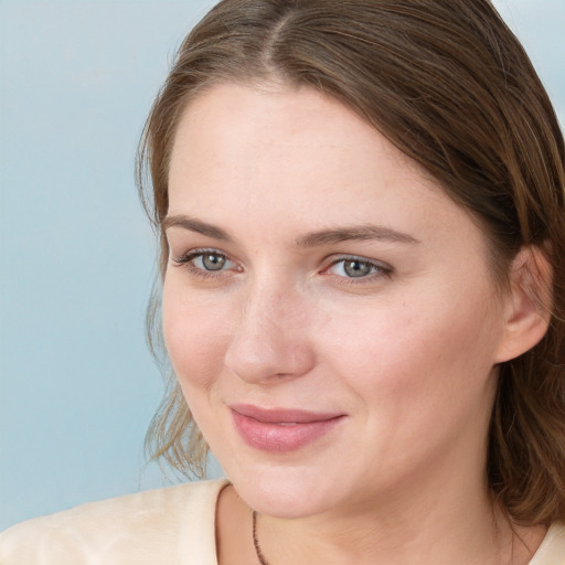 Joyful white young-adult female with medium  brown hair and blue eyes