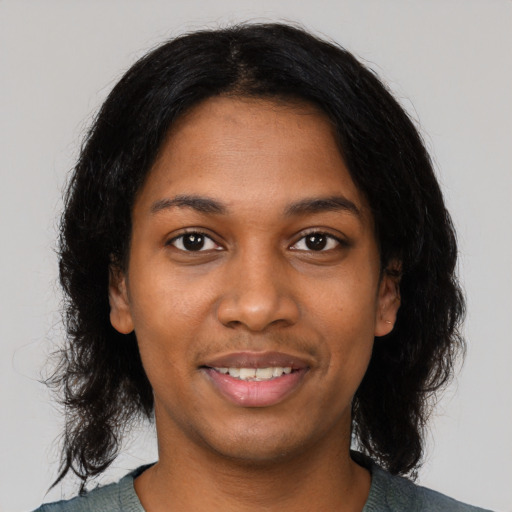 Joyful black young-adult female with medium  black hair and brown eyes