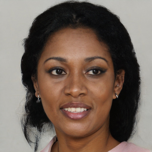 Joyful black young-adult female with medium  black hair and brown eyes