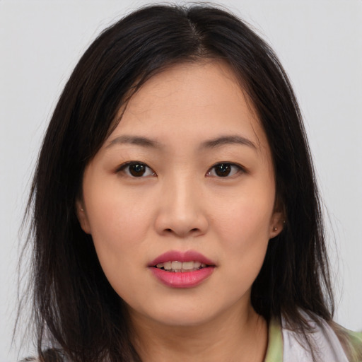 Joyful asian young-adult female with long  brown hair and brown eyes