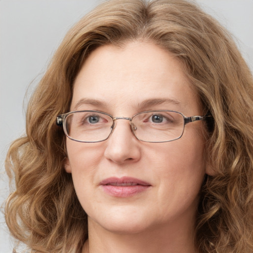 Joyful white adult female with long  brown hair and green eyes