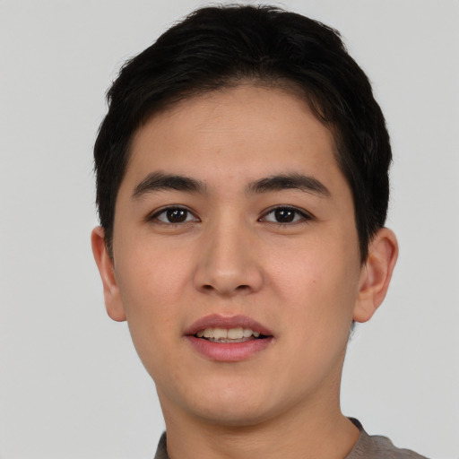 Joyful asian young-adult male with short  brown hair and brown eyes