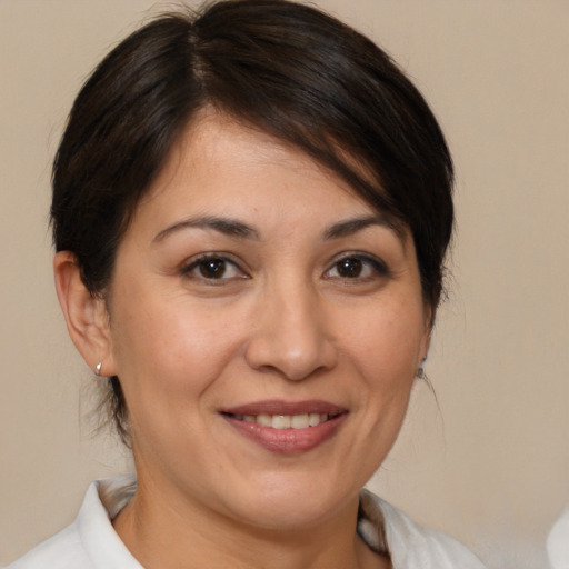 Joyful white adult female with medium  brown hair and brown eyes