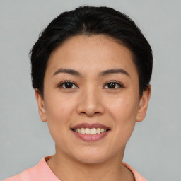 Joyful asian young-adult female with short  brown hair and brown eyes