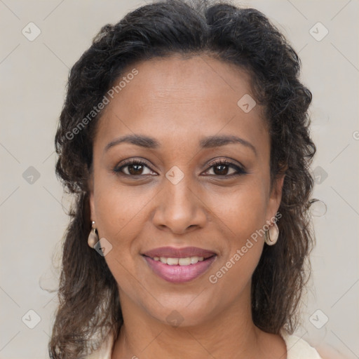 Joyful black young-adult female with long  brown hair and brown eyes
