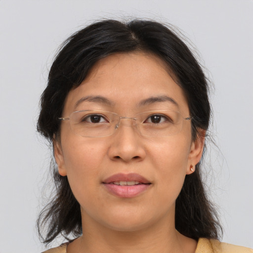 Joyful asian adult female with medium  brown hair and brown eyes