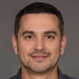 Joyful white adult male with short  brown hair and brown eyes