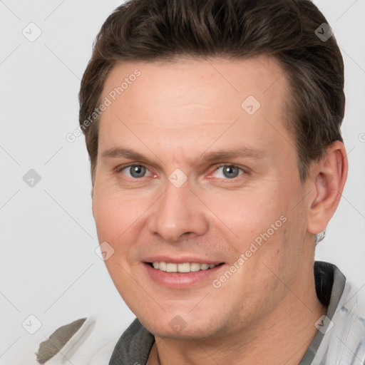 Joyful white adult male with short  brown hair and grey eyes