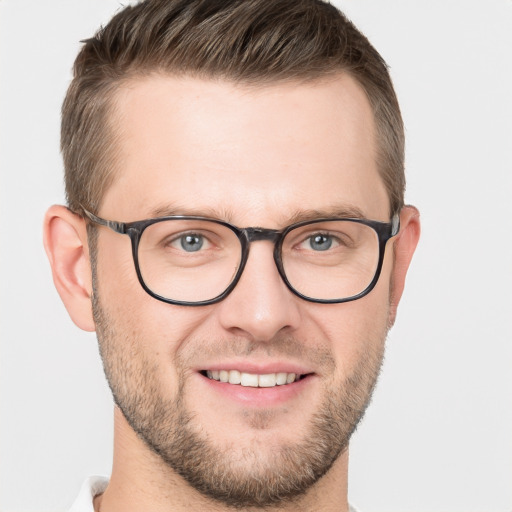 Joyful white adult male with short  brown hair and grey eyes