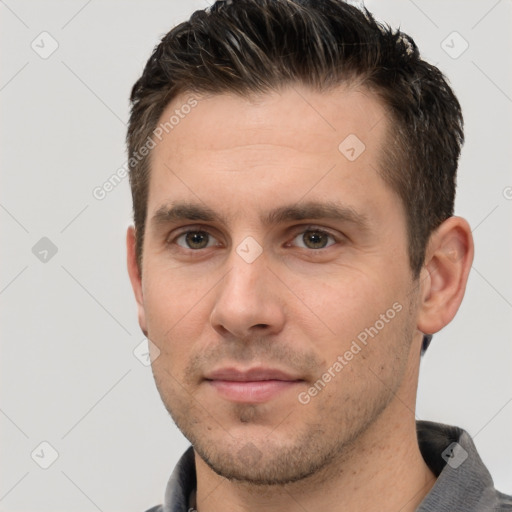 Joyful white young-adult male with short  brown hair and brown eyes