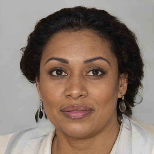 Joyful black adult female with short  brown hair and brown eyes