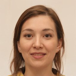 Joyful white young-adult female with medium  brown hair and brown eyes