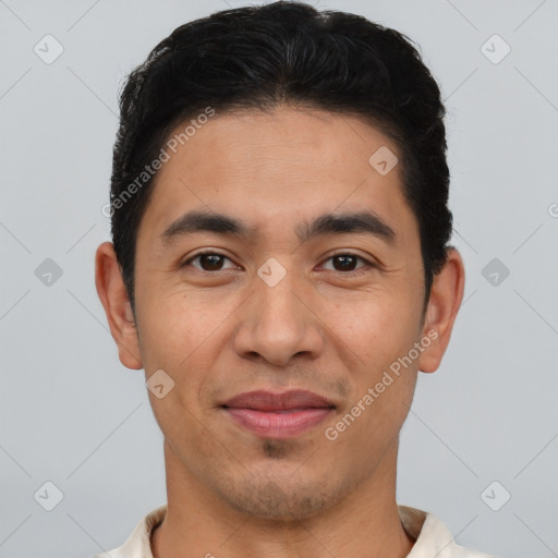 Joyful latino young-adult male with short  brown hair and brown eyes