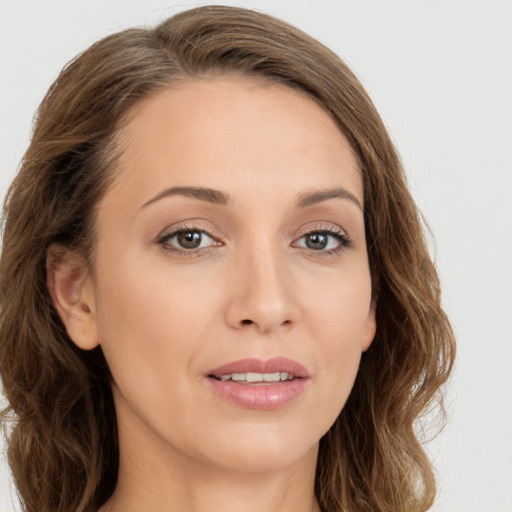 Joyful white young-adult female with long  brown hair and green eyes