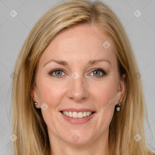 Joyful white adult female with long  brown hair and brown eyes