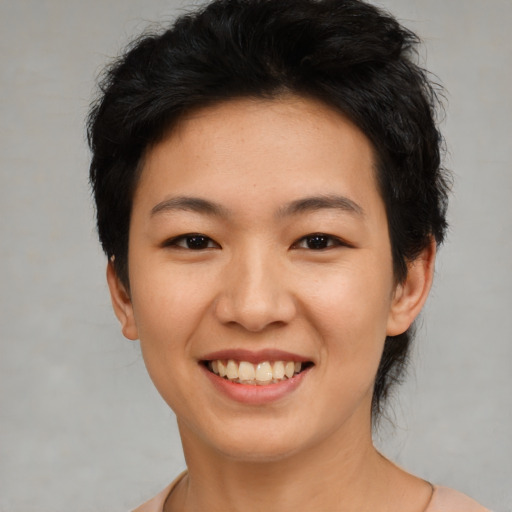 Joyful asian young-adult female with short  black hair and brown eyes