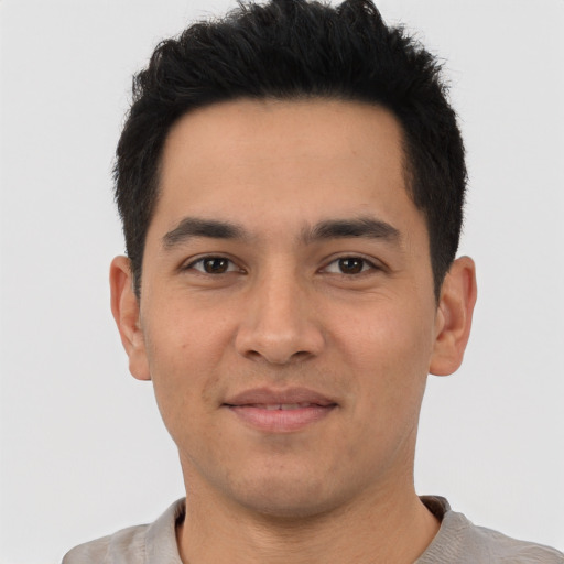 Joyful latino young-adult male with short  black hair and brown eyes