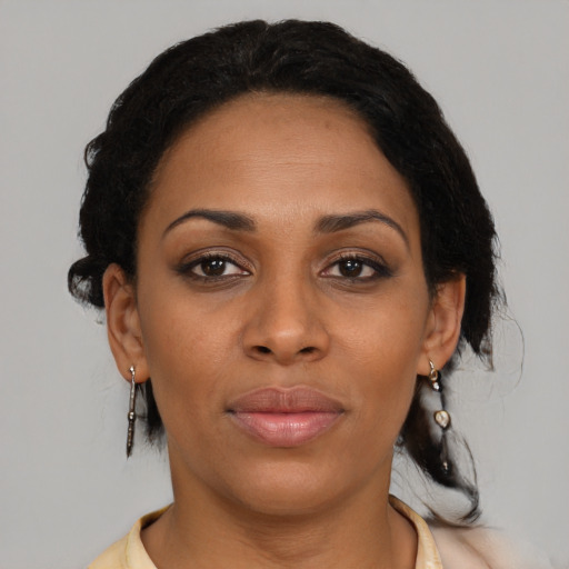 Joyful black young-adult female with medium  brown hair and brown eyes