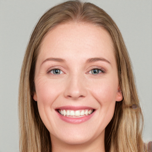 Joyful white young-adult female with long  brown hair and blue eyes