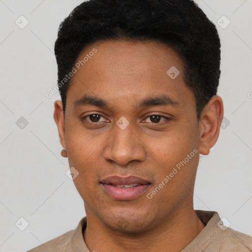 Joyful black young-adult male with short  black hair and brown eyes