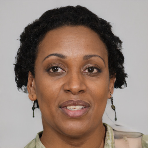 Joyful black adult female with short  brown hair and brown eyes