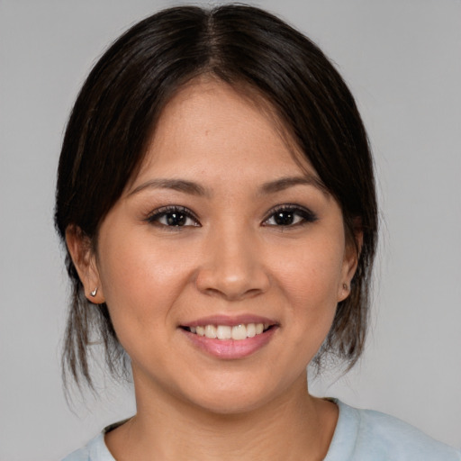 Joyful asian young-adult female with medium  brown hair and brown eyes