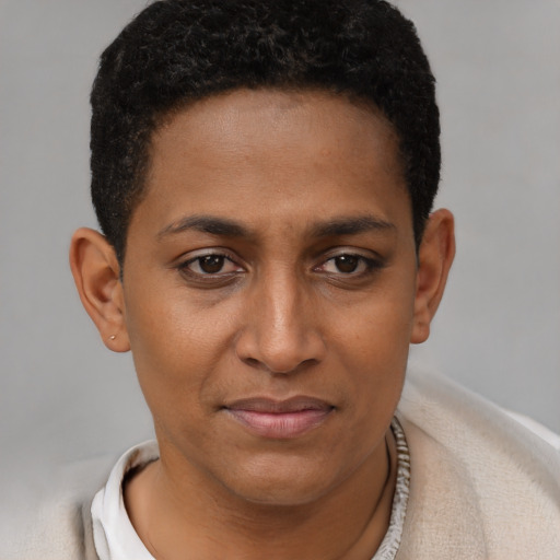 Joyful black young-adult female with short  brown hair and brown eyes