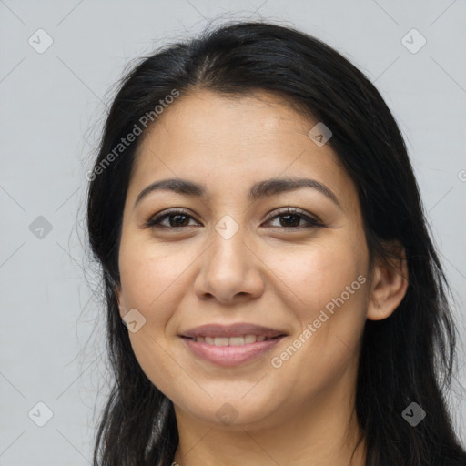 Joyful latino young-adult female with long  brown hair and brown eyes