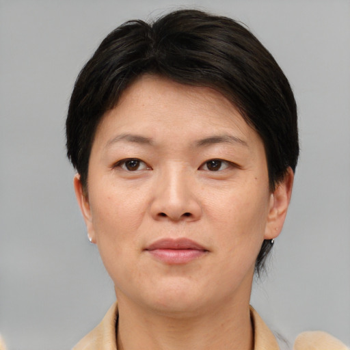 Neutral asian adult female with short  brown hair and brown eyes