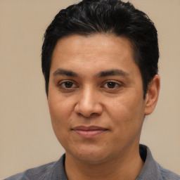 Joyful latino adult male with short  black hair and brown eyes