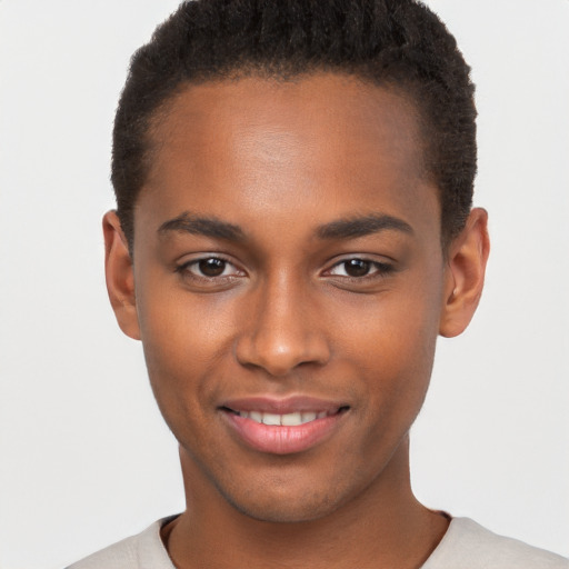 Joyful black young-adult male with short  brown hair and brown eyes